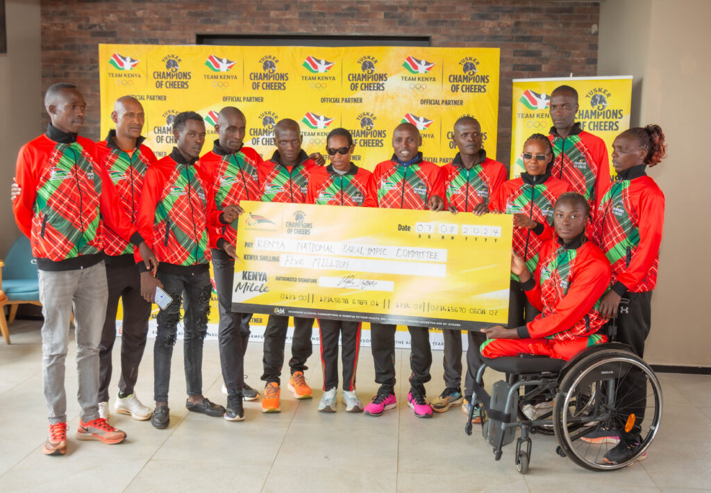 Kenya National Paralympic Team pose with a dummy cheque of Ksh 5 million from KBL